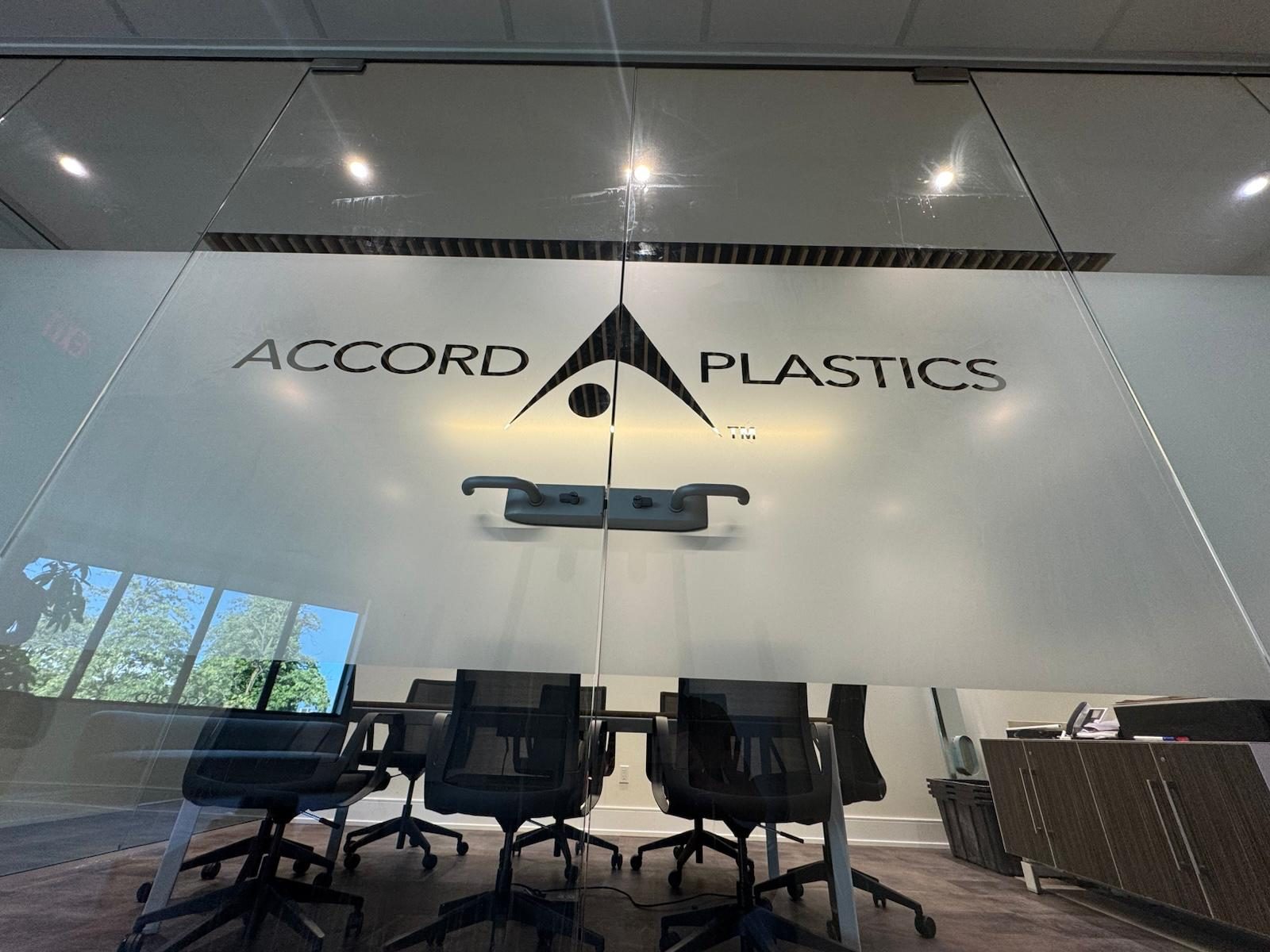 Boardroom glass wall with frosted privacy film and a cut-out company logo