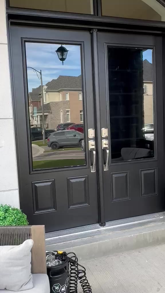 Black front entry doors with reflective tinted glass